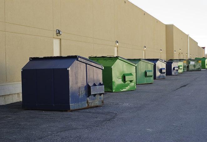 portable, green construction dumpsters serving as a container for scrap materials in Morgan